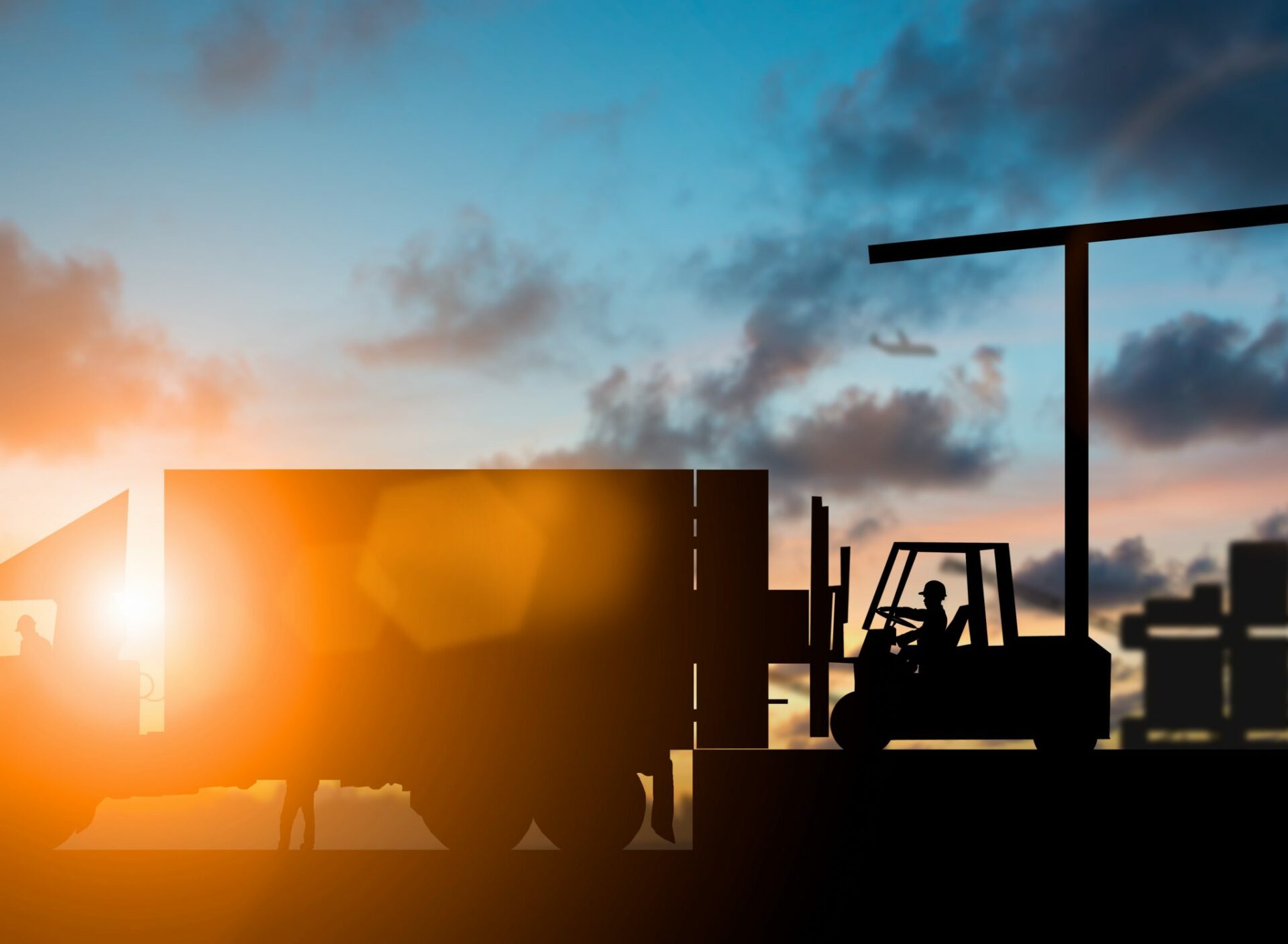 Silhouette,Forklift,Truck,Lifting,Cargo,Container,On,A,Truck,In