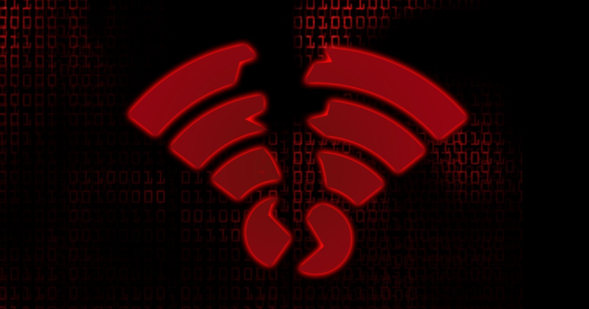 Ilustração de um símbolo de Wi-Fi em vermelho brilhante, destacando-se sobre um fundo preto com código binário em vermelho escuro, sugerindo um tema de ciberataque ou vulnerabilidade em redes sem fio (wi-fi, ciberataques, segurança, rede sem fio)